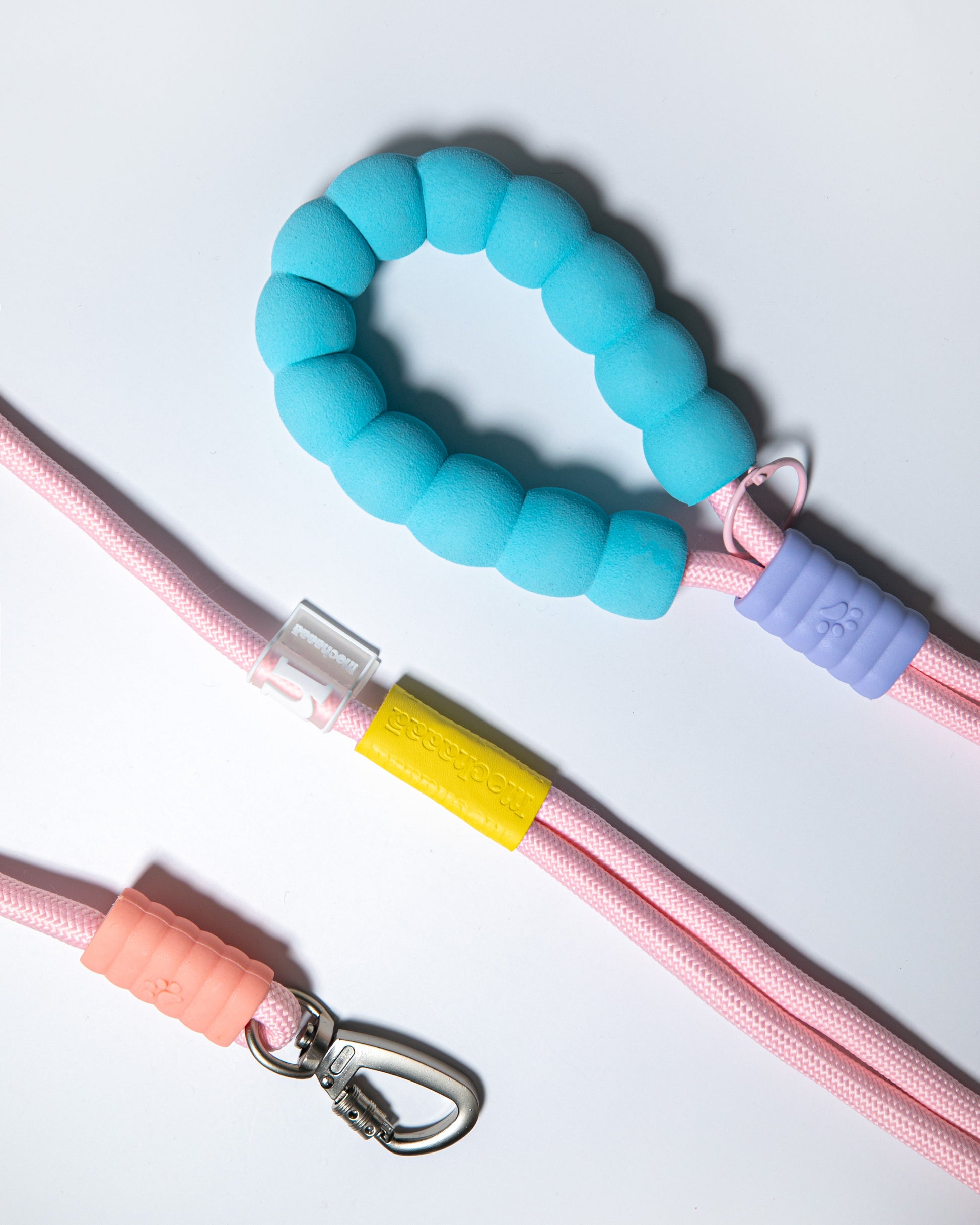 Durable pink rope dog leash with soft blue foam handle, yellow logo band, and secure metal clip – stylish pet leash for everyday walks