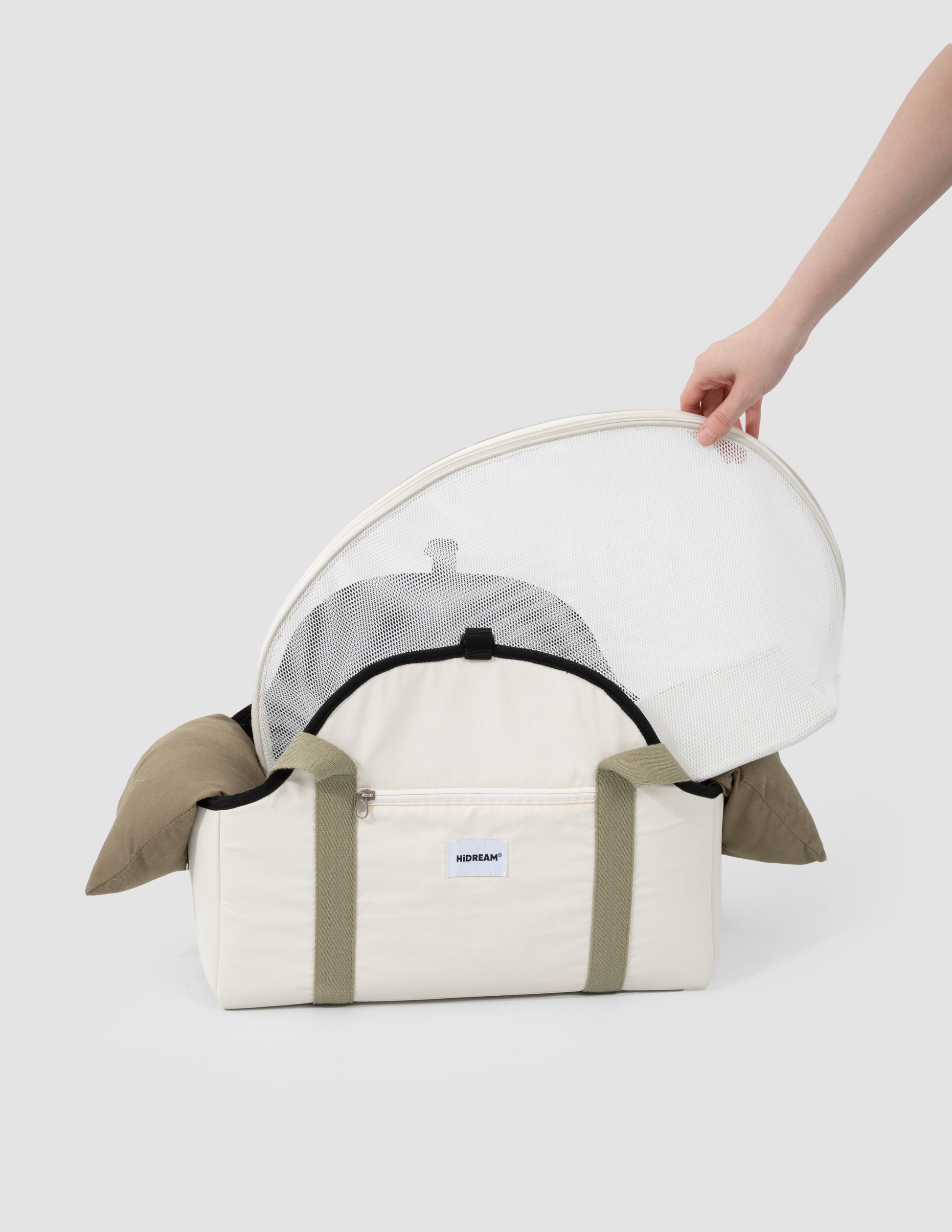 White pet carrier with transparent dome held by a hand on a white background