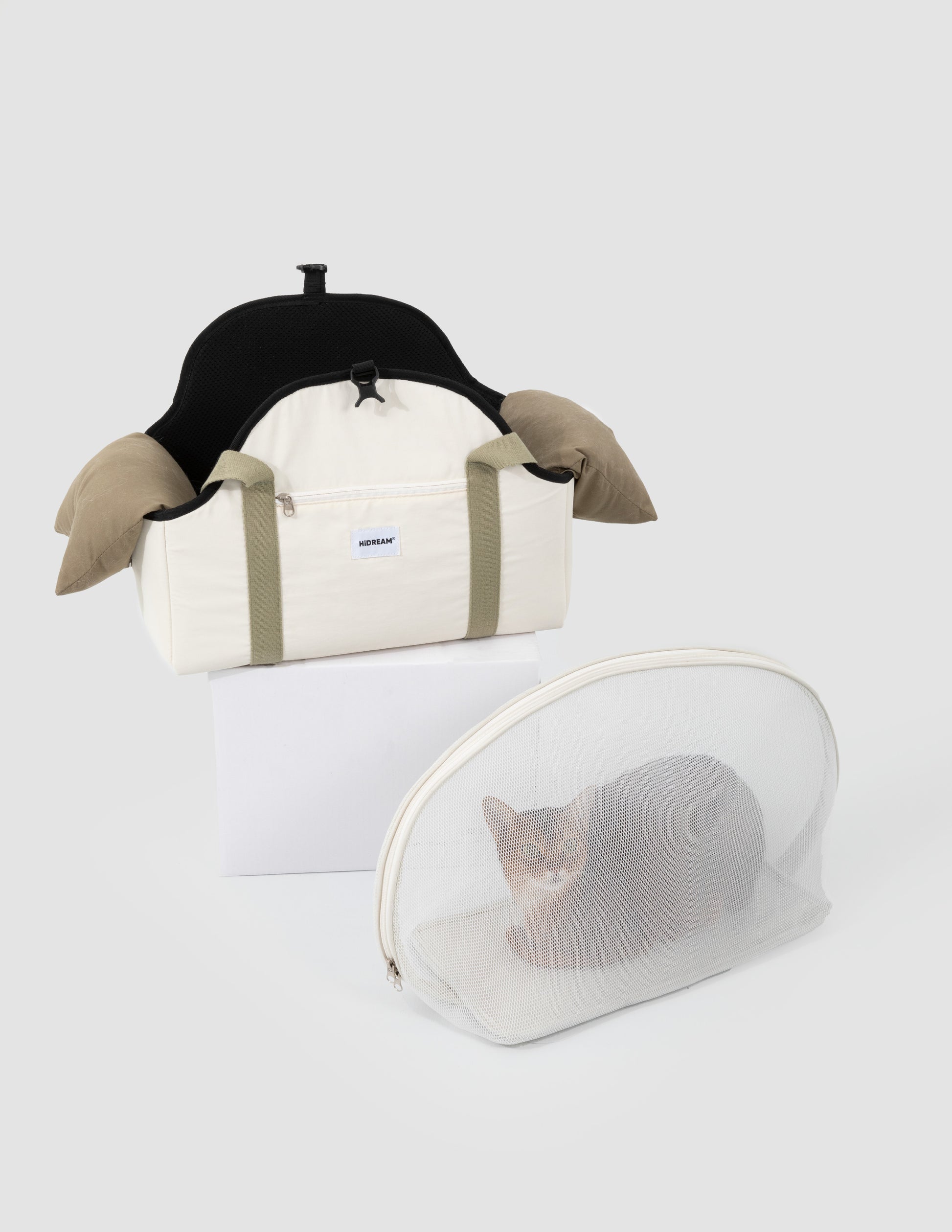 Two pet carriers, one with a black interior and beige exterior, and another transparent dome-style carrier with a cat inside on a white background.