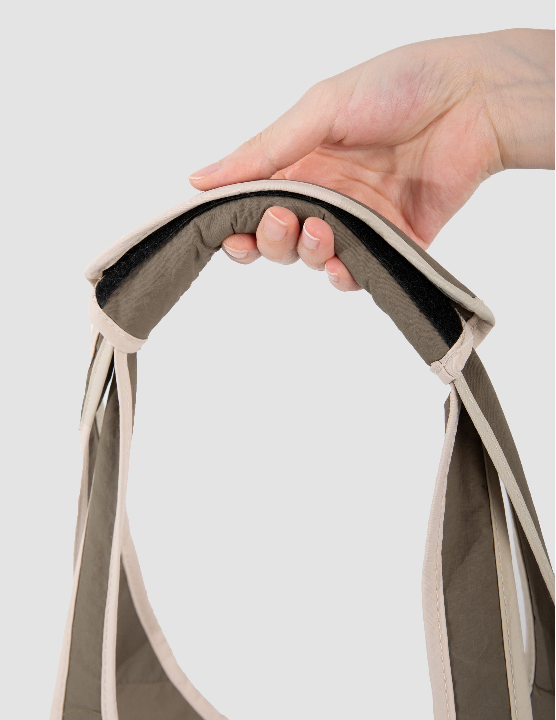 hand holding a brown bag handle