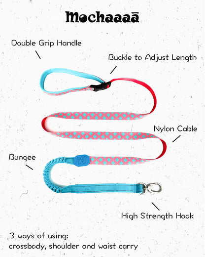 Colorful pink and teal patterned dog leash with padded handle, bungee shock absorber, and metal clip